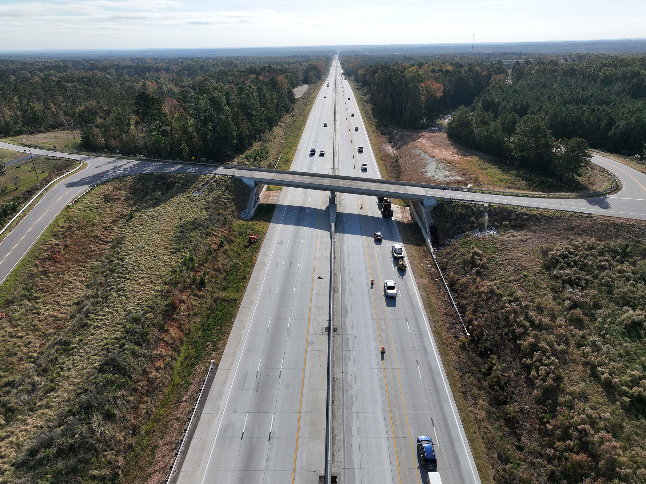 As the work is completed, additional lanes on I-26 will be opened to traffic. The seven new overpass bridges were all lengthened to span the additional lanes. This photo shows all three lanes of Westbound I-26 that are now open in Segment 3.